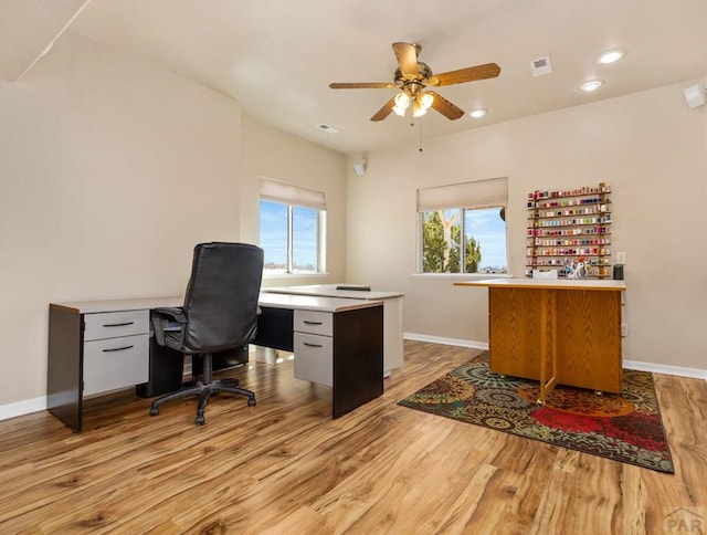 home office with light wood finished floors, recessed lighting, visible vents, a ceiling fan, and baseboards