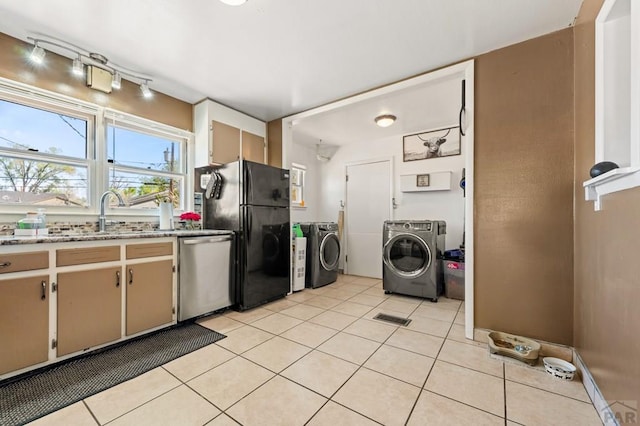 kitchen featuring visible vents, freestanding refrigerator, washer and dryer, dishwasher, and light tile patterned floors