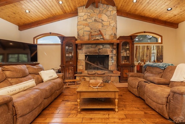 living area featuring a fireplace, recessed lighting, lofted ceiling with beams, wood ceiling, and hardwood / wood-style floors