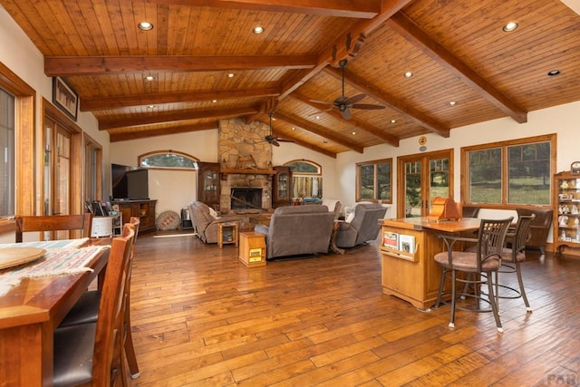 interior space with a stone fireplace, hardwood / wood-style floors, and a wealth of natural light