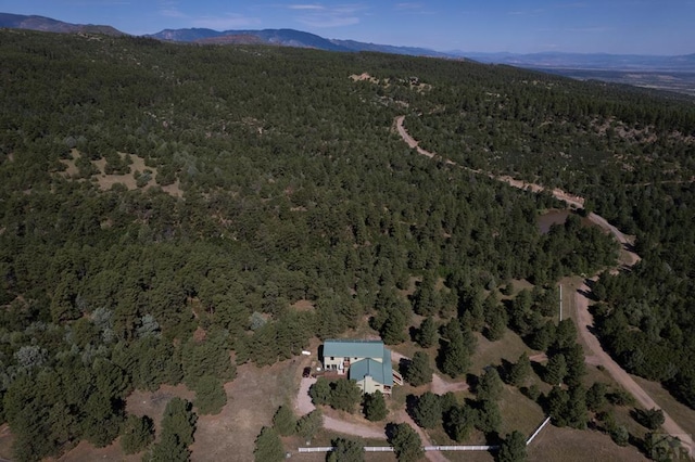 bird's eye view featuring a forest view and a mountain view