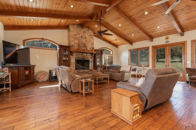 living area with wood ceiling, hardwood / wood-style floors, a fireplace, and a ceiling fan