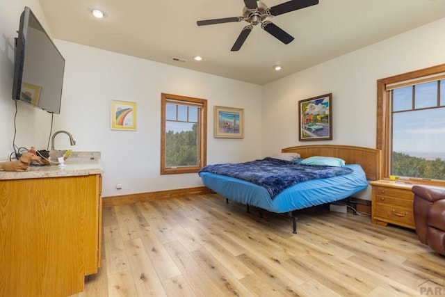 bedroom with light wood finished floors, visible vents, baseboards, ceiling fan, and recessed lighting