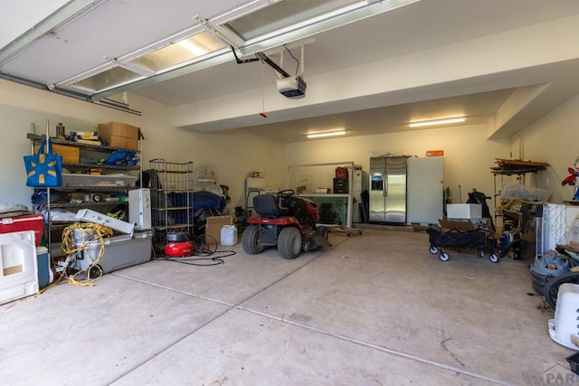 garage featuring stainless steel fridge and a garage door opener