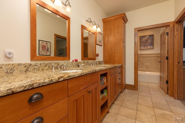 full bathroom featuring a bathtub, tile patterned flooring, and vanity