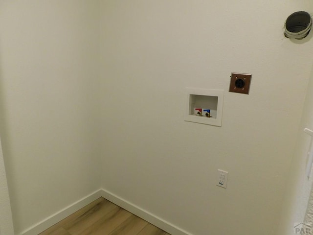 washroom featuring washer hookup, hookup for an electric dryer, wood finished floors, laundry area, and baseboards