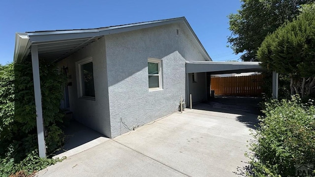 1728 Euclid Ave, Pueblo, CO 81004 - view of property exterior with stucco siding, a carport, and driveway