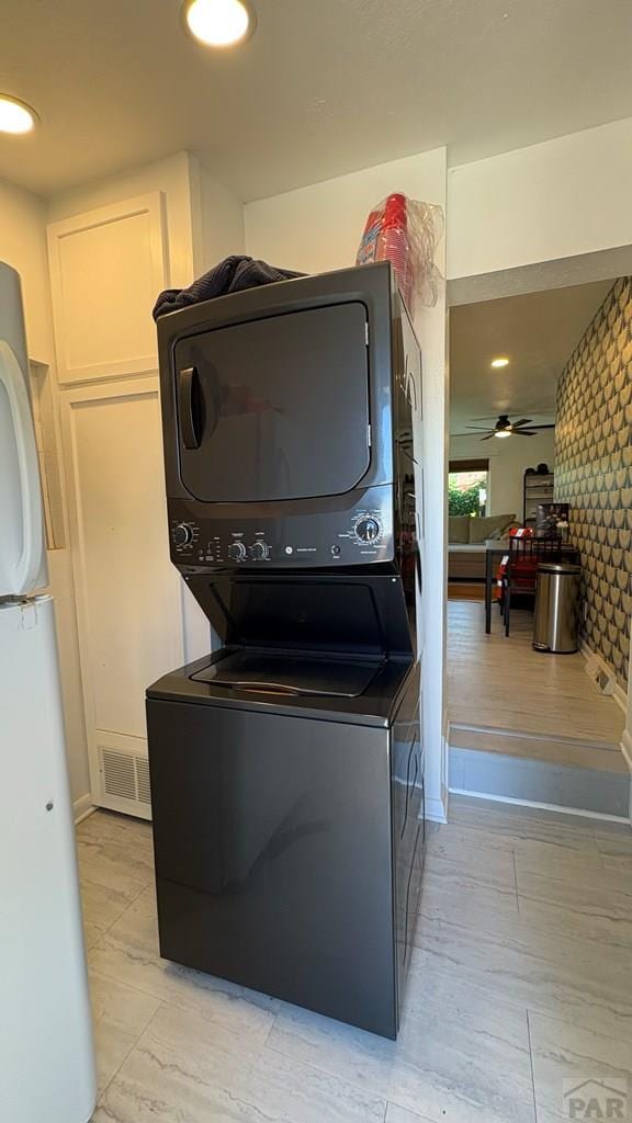 1728 Euclid Ave, Pueblo, CO 81004 - laundry room with estacked washer and dryer, wallpapered walls, and a ceiling fan