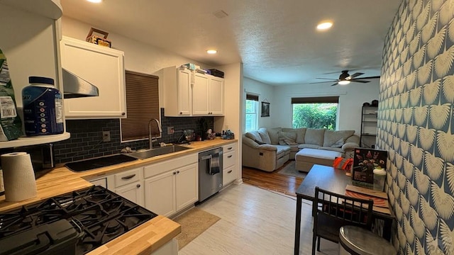 1728 Euclid Ave, Pueblo, CO 81004 - kitchen with stainless steel dishwasher, wood counters, tasteful backsplash, ceiling fan, and light wood-style flooring