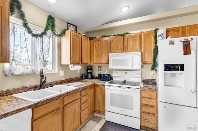 kitchen with light tile patterned floors, lofted ceiling, white appliances, a sink, and light countertops