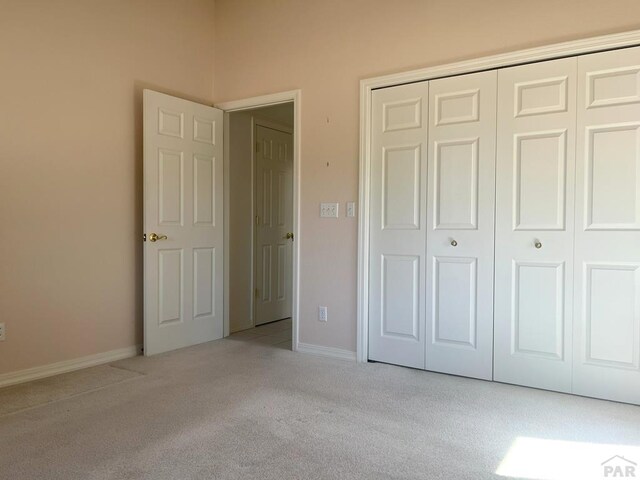 165 Kingsley Ave Unit M, Pueblo, CO 81005 - unfurnished bedroom featuring carpet flooring, a closet, and baseboards