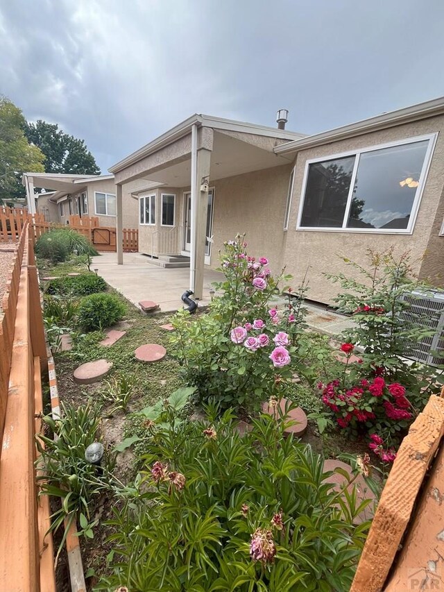 165 Kingsley Ave Unit M, Pueblo, CO 81005 - back of house featuring stucco siding, a patio area, and central AC unit