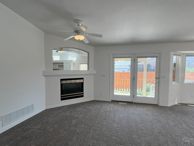 165 Kingsley Ave Unit M, Pueblo, CO 81005 - unfurnished living room with ceiling fan, baseboards, and dark carpet