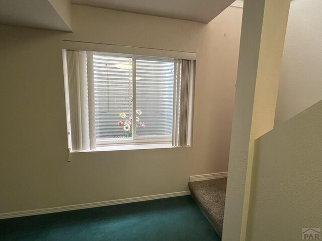 165 Kingsley Ave Unit M, Pueblo, CO 81005 - empty room with dark carpet and baseboards