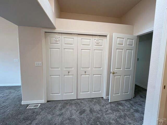165 Kingsley Ave Unit M, Pueblo, CO 81005 - unfurnished bedroom featuring dark colored carpet, a closet, and baseboards