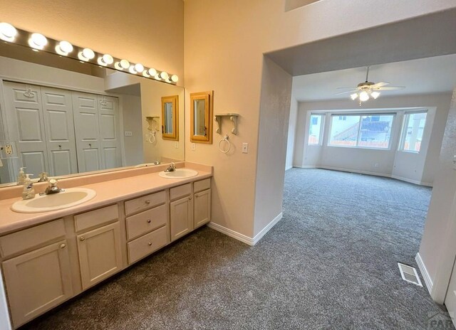 165 Kingsley Ave Unit M, Pueblo, CO 81005 - full bath with carpet floors, baseboards, double vanity, a ceiling fan, and a towering ceiling