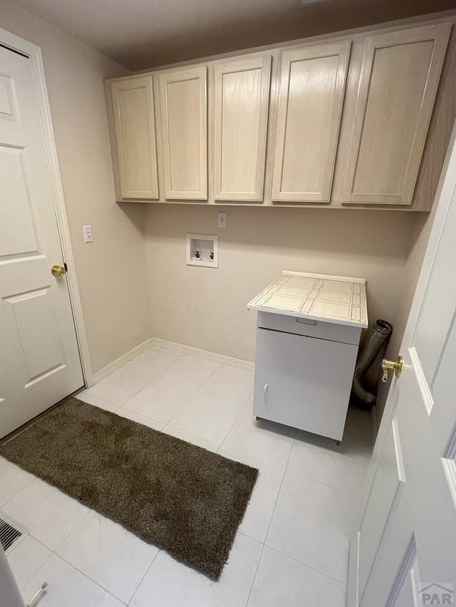 165 Kingsley Ave Unit M, Pueblo, CO 81005 - laundry room with cabinet space, washer hookup, tile patterned flooring, and baseboards