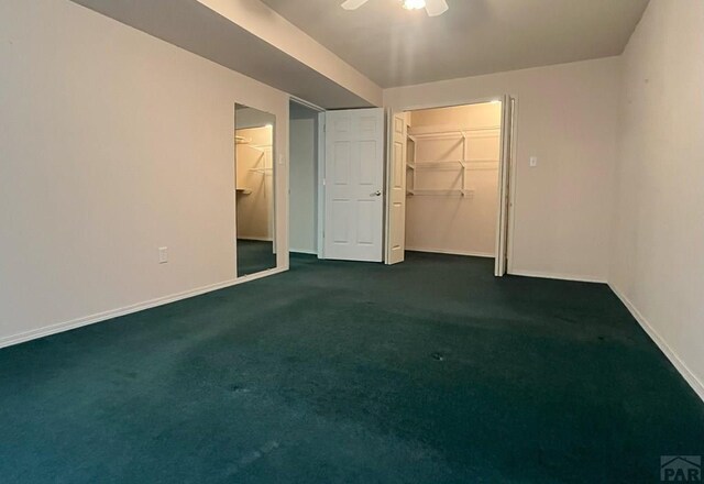 165 Kingsley Ave Unit M, Pueblo, CO 81005 - unfurnished bedroom featuring baseboards, dark colored carpet, a closet, and a spacious closet
