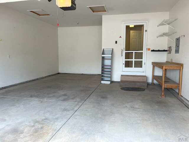 165 Kingsley Ave Unit M, Pueblo, CO 81005 - garage with a garage door opener and electric panel