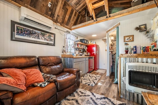 9016 Pine Ave, Beulah, CO 81023 - living area with vaulted ceiling, a wall unit AC, heating unit, and wood finished floors