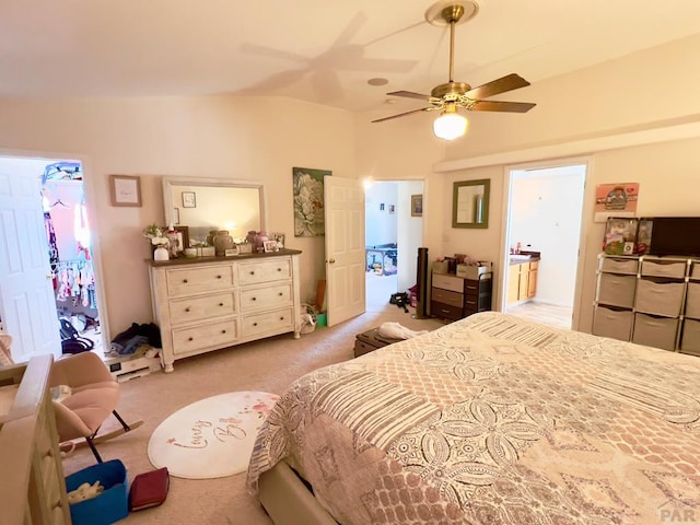 bedroom with light carpet, ensuite bath, and a ceiling fan