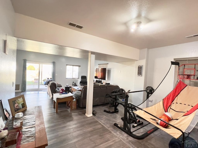 exercise area with visible vents and wood finished floors