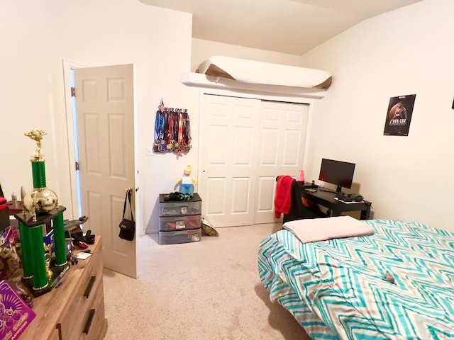 bedroom featuring lofted ceiling and a closet