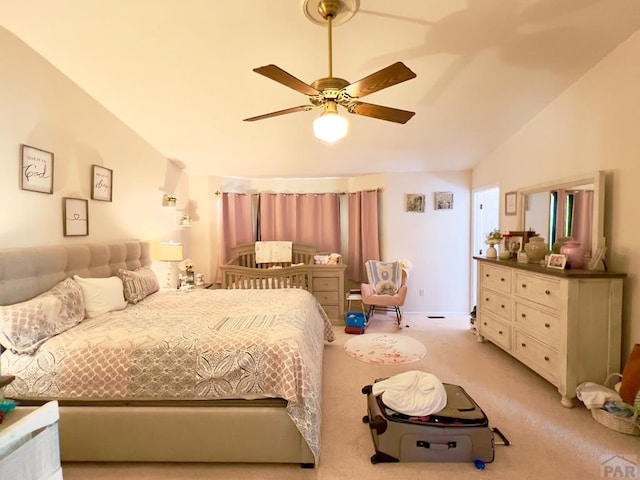 bedroom with lofted ceiling, a ceiling fan, and light colored carpet