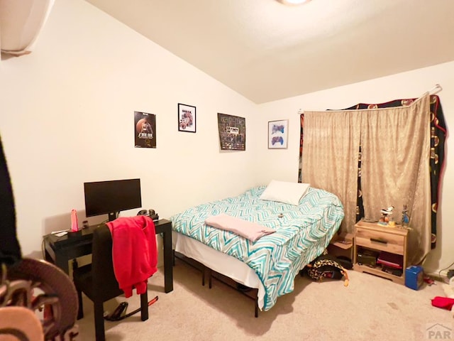 bedroom featuring lofted ceiling and carpet floors