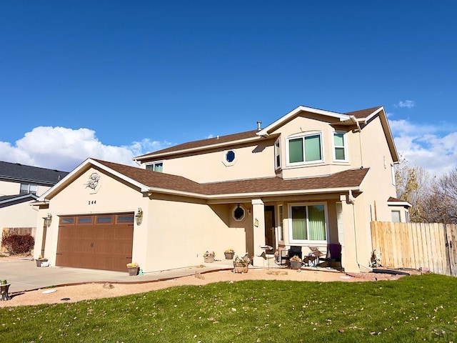 traditional-style home featuring stucco siding, a front yard, fence, a garage, and driveway