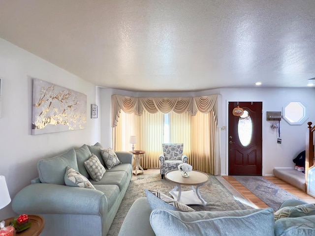 living area with a textured ceiling and wood finished floors