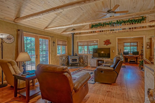 living room featuring light wood-type flooring, french doors, wooden ceiling, and a wood stove