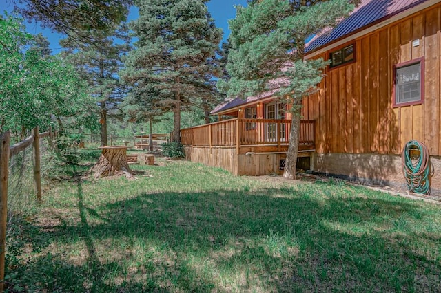 view of yard featuring fence and a wooden deck