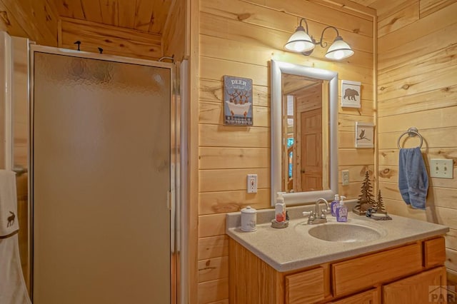 full bath featuring wooden ceiling, wood walls, a shower stall, and vanity