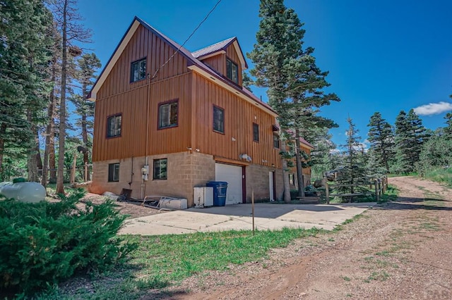 view of home's exterior with a garage and concrete driveway