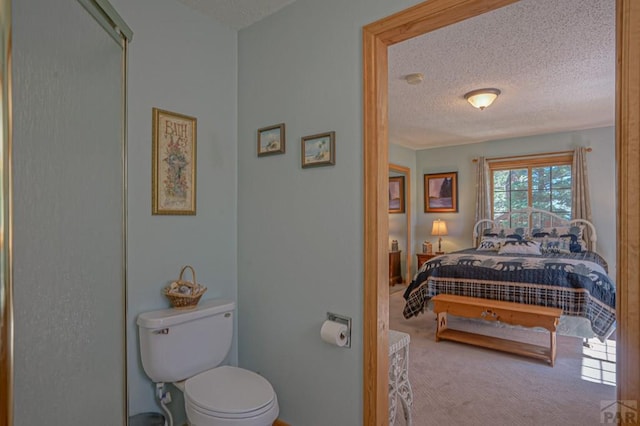 bathroom with a textured ceiling and toilet