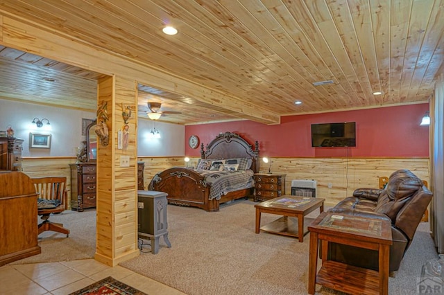 carpeted bedroom featuring tile patterned flooring, wooden ceiling, a wainscoted wall, and wooden walls