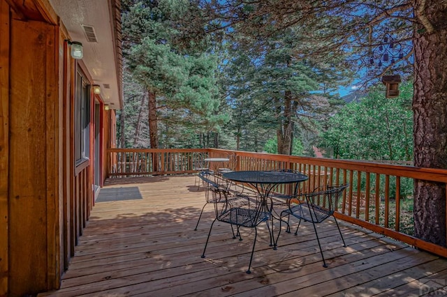 wooden deck with outdoor dining space