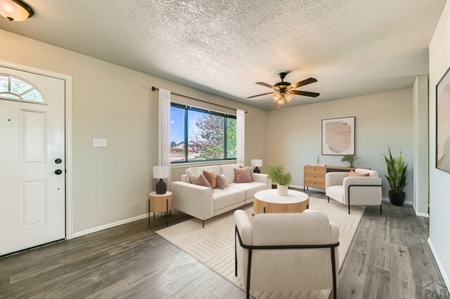950 S Los Charros Dr, Pueblo West, CO 81007 - living area featuring wood finished floors, a textured ceiling, and a ceiling fan