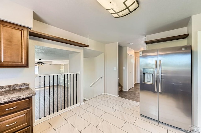 950 S Los Charros Dr, Pueblo West, CO 81007 - kitchen with stainless steel fridge with ice dispenser, ceiling fan, dark countertops, and brown cabinets