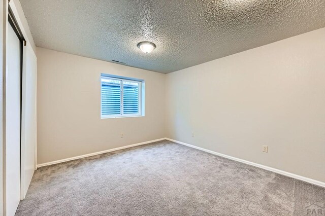 950 S Los Charros Dr, Pueblo West, CO 81007 - empty room featuring carpet flooring and a textured ceiling