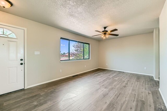 950 S Los Charros Dr, Pueblo West, CO 81007 - entrance foyer with wood finished floors, a textured ceiling, and ceiling fan