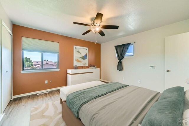 950 S Los Charros Dr, Pueblo West, CO 81007 - bedroom with wood finished floors, a ceiling fan, and a closet