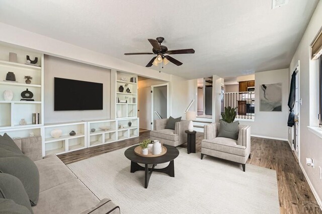 950 S Los Charros Dr, Pueblo West, CO 81007 - living area featuring wood finished floors, a ceiling fan, and built in shelves
