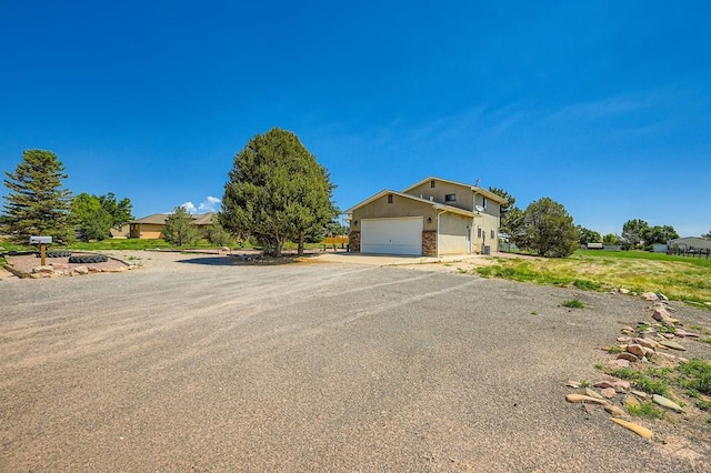 950 S Los Charros Dr, Pueblo West, CO 81007 - view of front facade with a garage and driveway