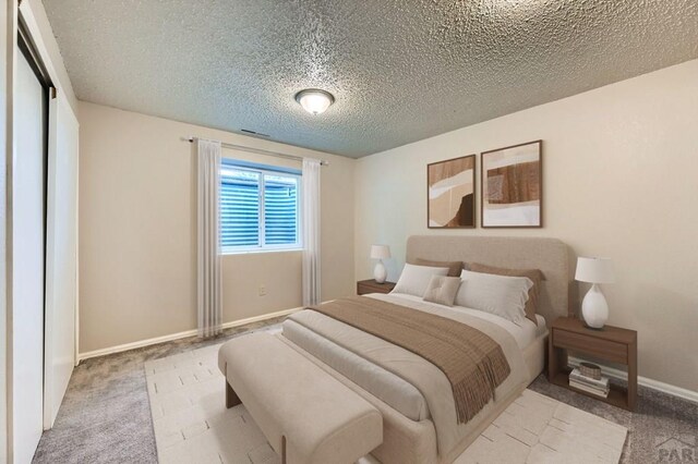 950 S Los Charros Dr, Pueblo West, CO 81007 - carpeted bedroom with baseboards and a textured ceiling