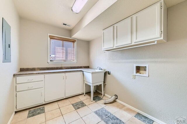 950 S Los Charros Dr, Pueblo West, CO 81007 - laundry room featuring cabinet space, washer hookup, electric panel, and light tile patterned floors