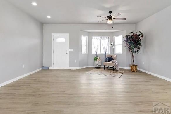 foyer entrance featuring baseboards and light wood-style flooring