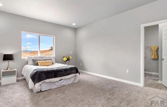 carpeted bedroom with recessed lighting and baseboards