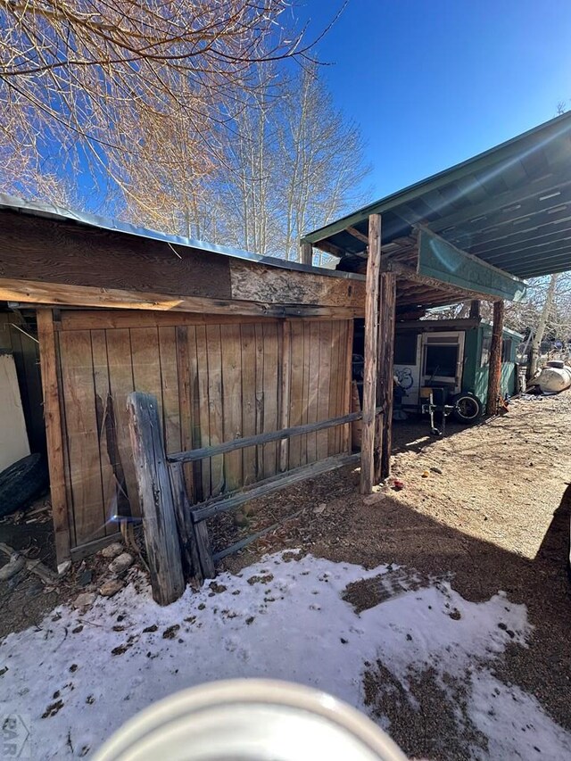 exterior space with a carport and an outdoor structure